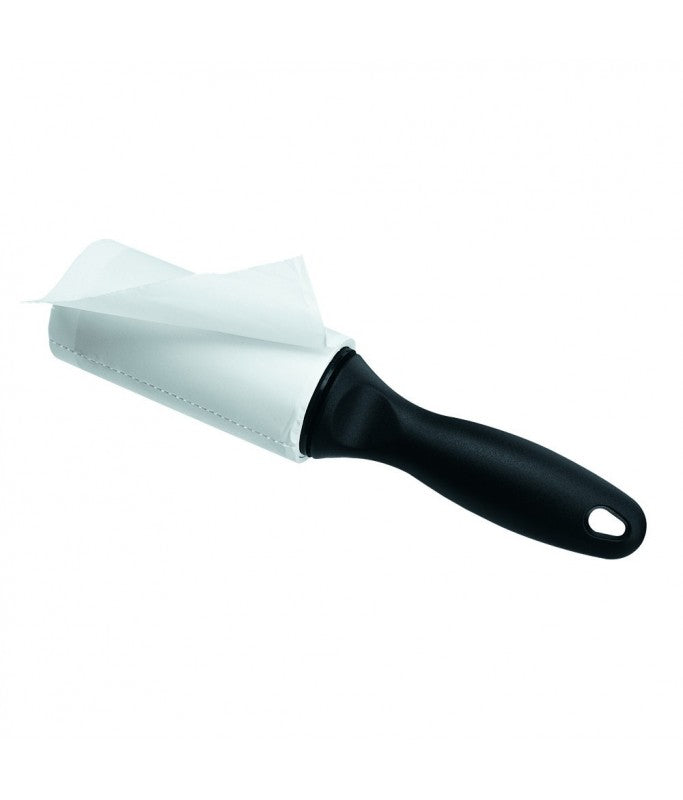Cleaning brush with black handle and white bristle head on a white background