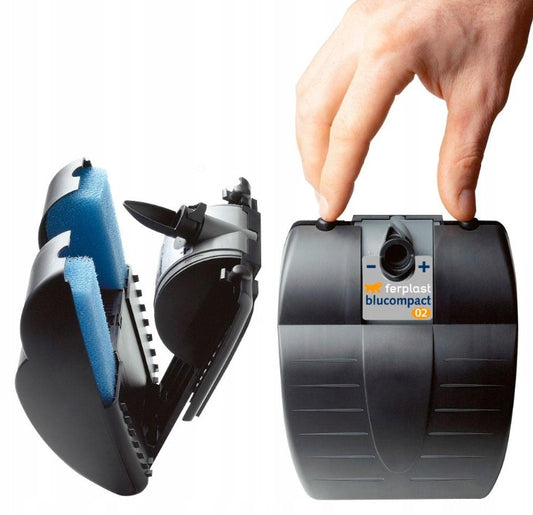 Hand holding a black blucompact device with blue strap, on a white background