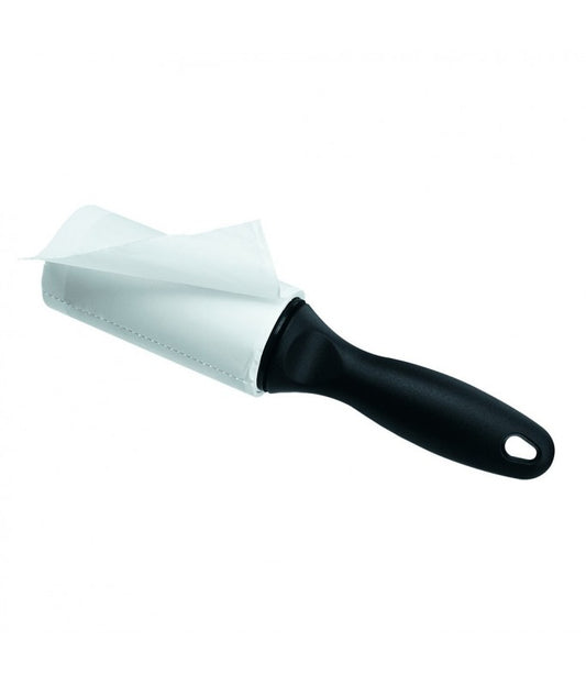 Cleaning brush with black handle and white bristle head on a white background